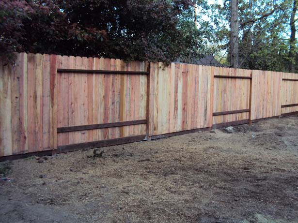 completed fence with 6 inch pressure-treated kickboard