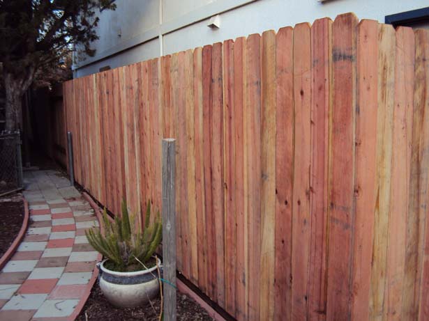completed fence with 6 inch pressure-treated kickboard